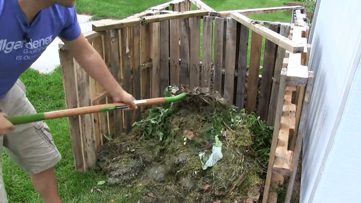 A man shoveling compost.