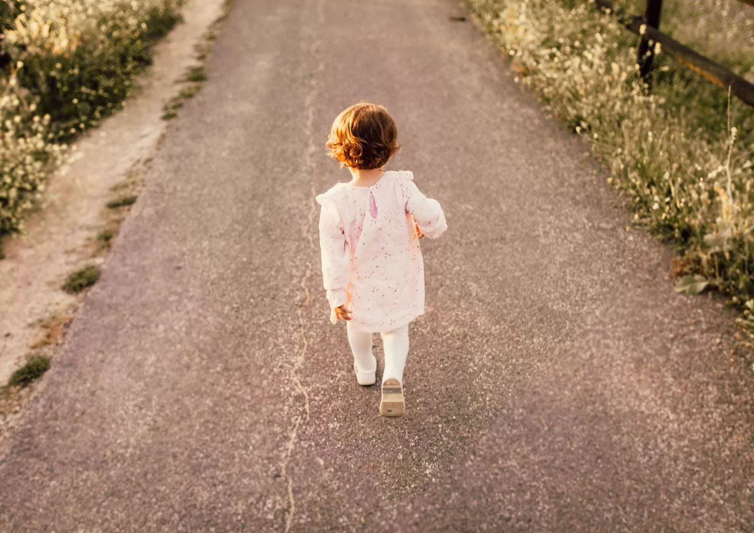 little girl walking on an emptly road