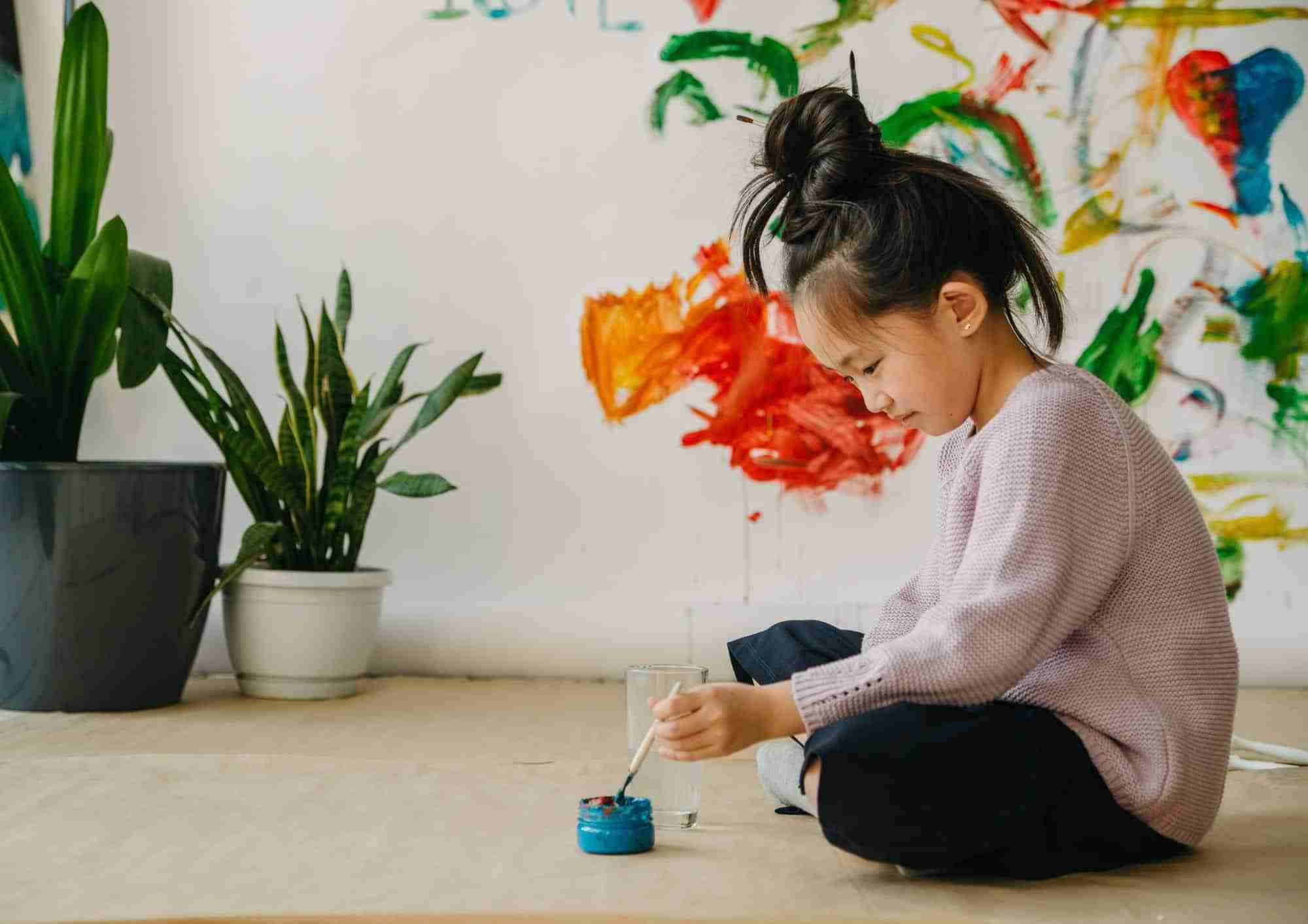 Child painting on wall