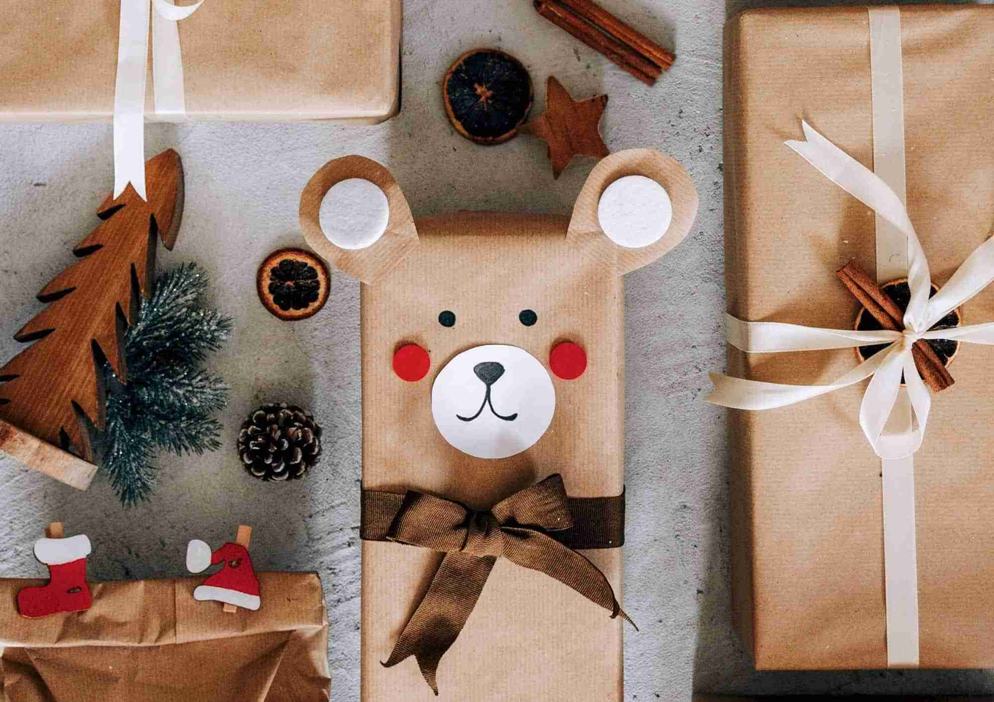 Christmas presents made to look like a teddy bear wrapped with recycled brown paper.