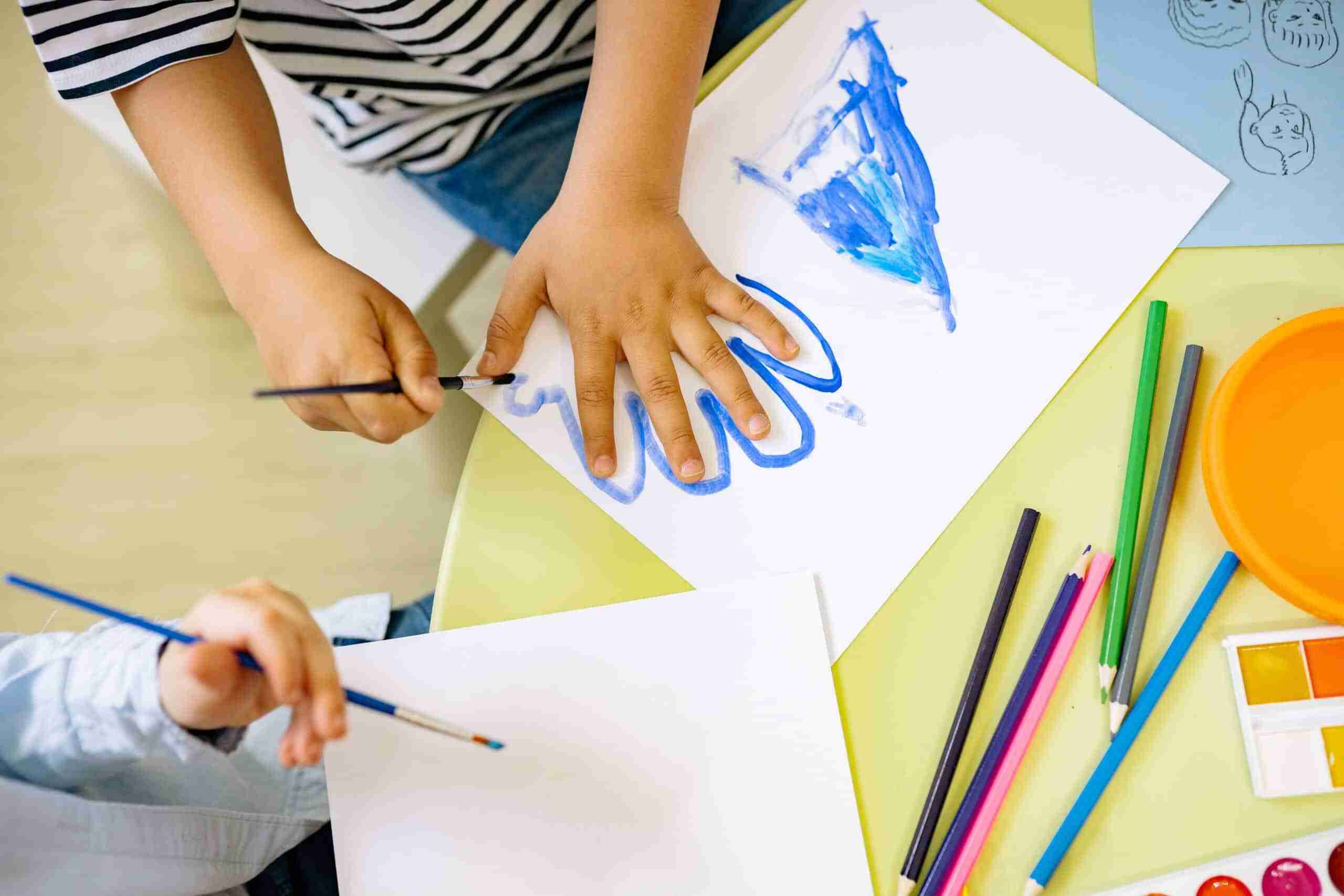 Children tracing their hand - Pip & Henry