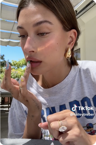 Hailey Bieber posted a rare makeup tutorial on TikTok, sharing her new go-to look, Strawberry makeup, looking fresh-faced and beautiful.