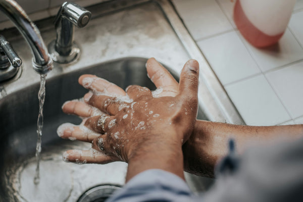 man washes hands