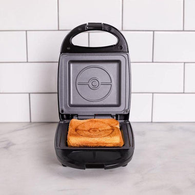 https://cdn.shopify.com/s/files/1/0575/4381/9429/products/Uncanny-Brands-Pokemon-Pokeball-Single-Cheese-Toastie-Maker-2.jpg?v=1688021965&width=380