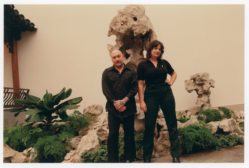 Loney Abrams and Johnny Stanish posing at Astor Chinese Garden Court at The Met in New York.