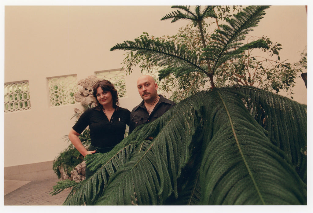 Loney Abrams and Johnny Stanish posing at Astor Chinese Garden Court at The Met in New York.