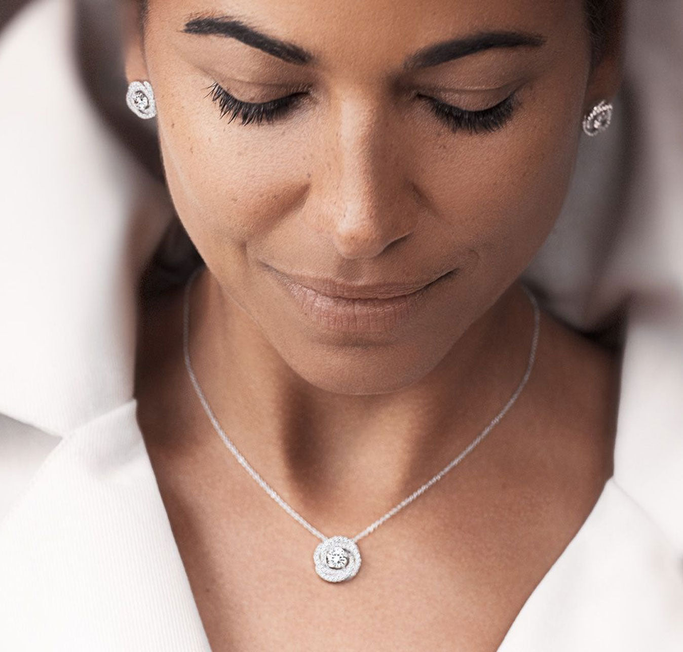 A woman in a white shirt and necklace, representing Lafonn's belief in making beautiful jewelry accessible to all women.