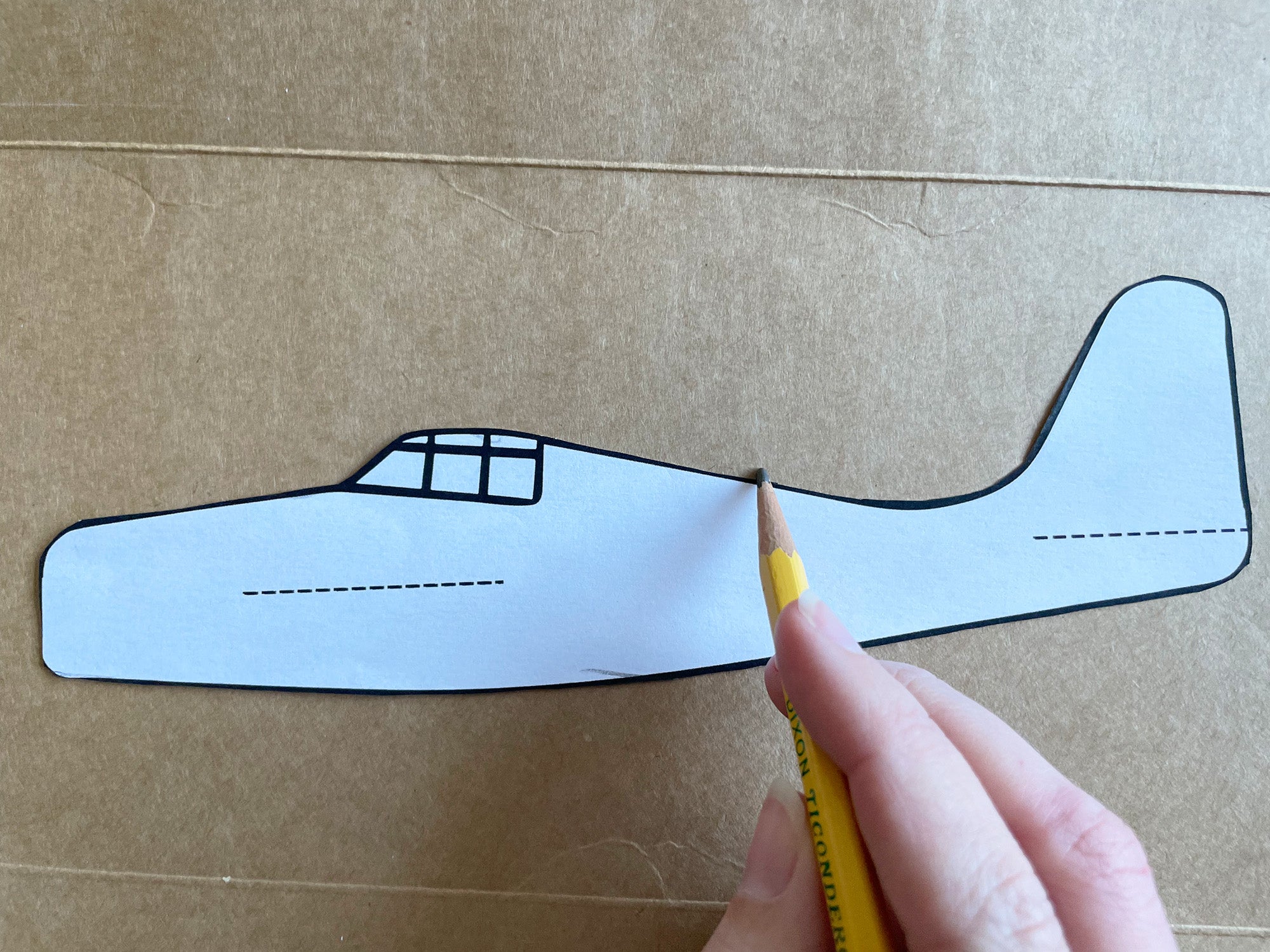 Tracing around the template onto cardboard 