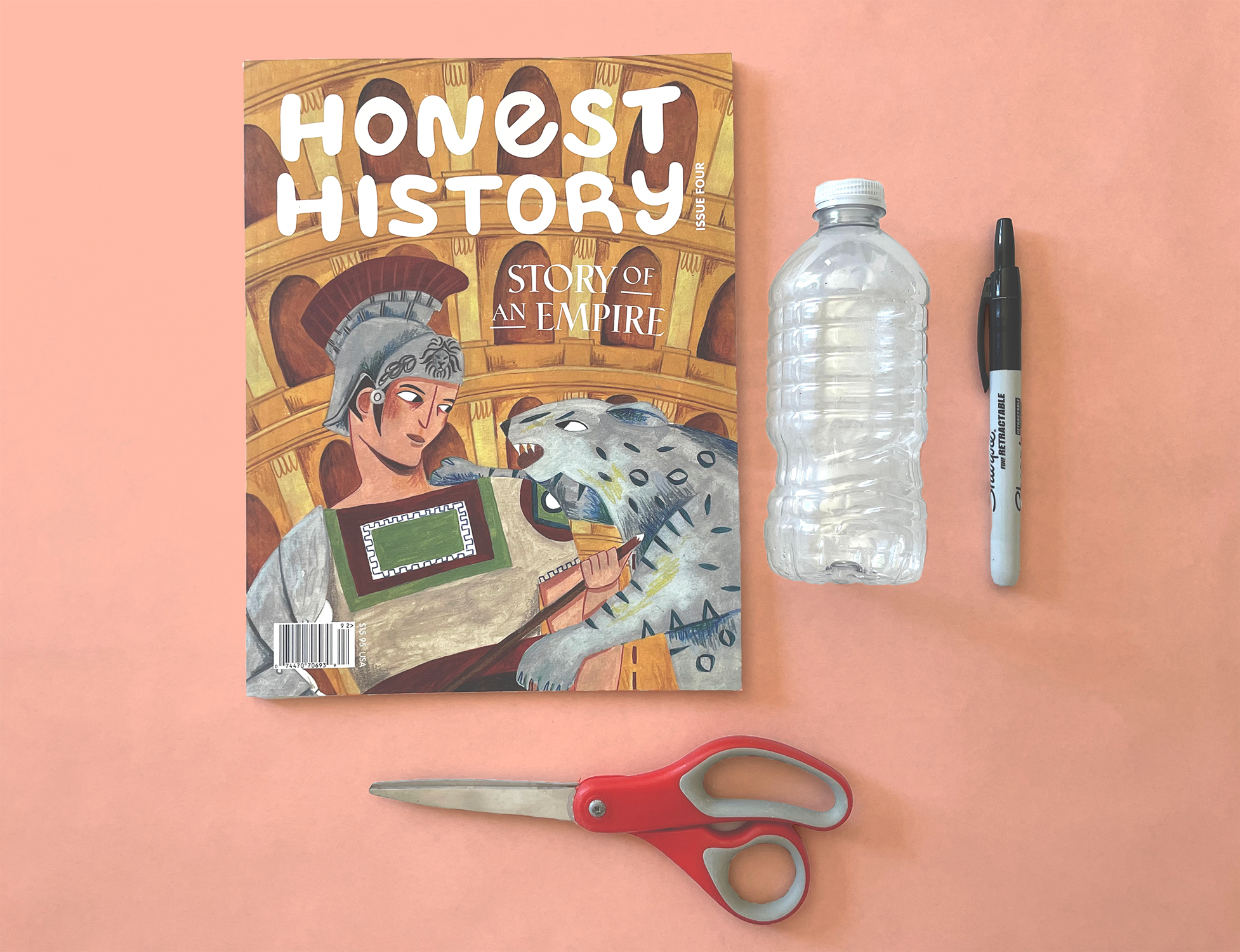 Honest History Magazine Issue 4 with a water bottle, pen, and scissors