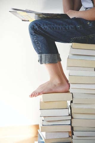 Pile of books and child