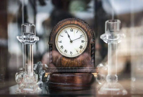 An antique clock shows 11:11 with its hands