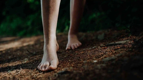 Someone walks barefoot at night for grounding