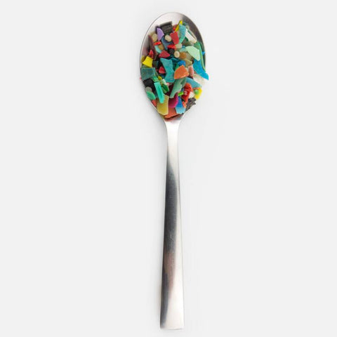 Steel spoonful of colorful microplastics