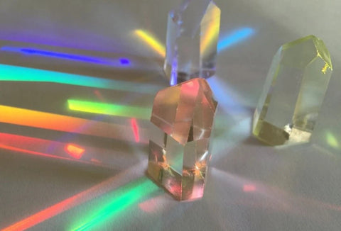 Lemurian crystals refract rainbow light onto a table