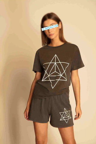 Girl wears a t-shirt with Merkaba print