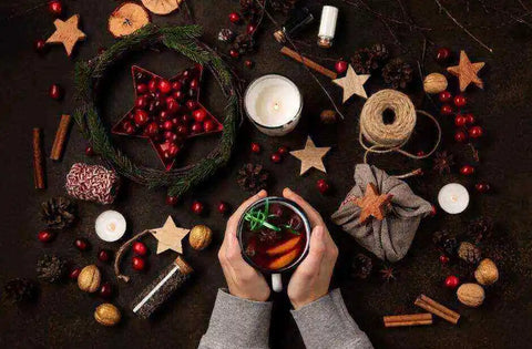 A Yuletide reveler makes a wassail drink