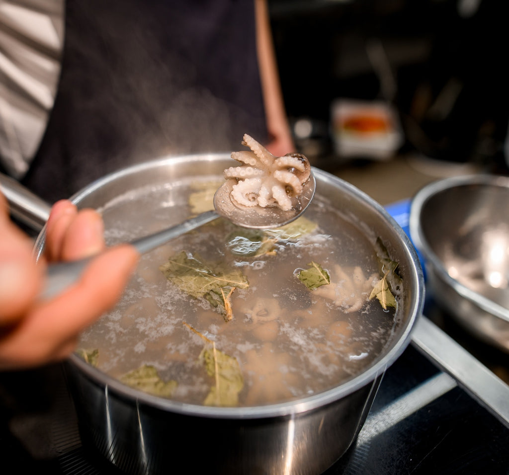 Baby Octopus boiling in large pot