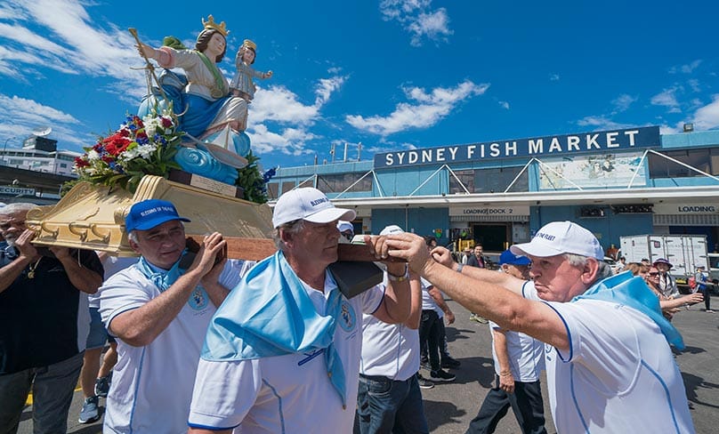 The replica Madonna, Santa Maria Di Porto Salvo (Our Lady of Safe Harbour), guardian of seafarers and fishermen, is processed through the Sydney Fish Markets.