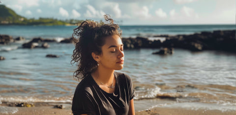 a teenager practicing mindfulness on a beach