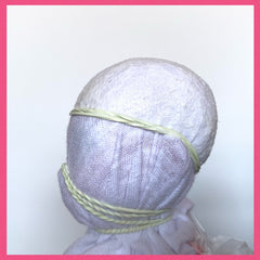 Doll head wrapped with T-shirt side view