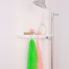 Clean Green and Coral Clean WOWOs hanging to dry in a clean white shower