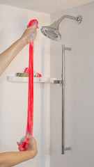 woman's hands stretch a Punch Clean WOWO exfoliating mesh body scrubber in the shower