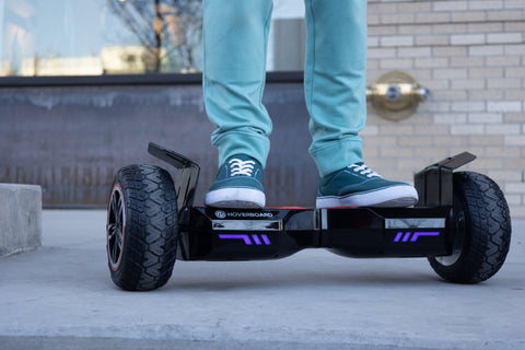 Child riding a Black E4 Hoverboard with Off-Road Tires