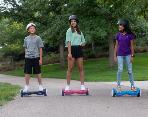 3 Children riding GOTRAX Drift LED Hoverboards for Kids with LED Wheels 