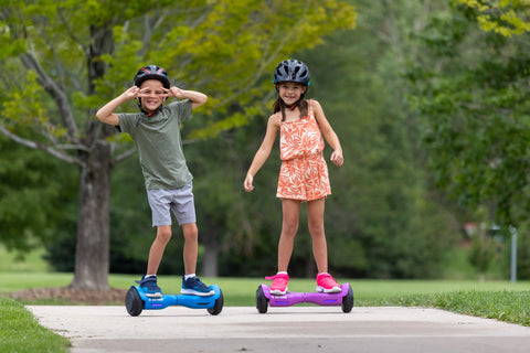 Children riding GOTRAX Blue and Purple Lil Cub Hoverboard for Kids