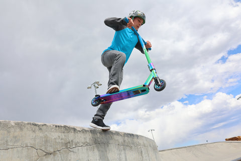 Child riding GOTRAX ST PRO 300 Stunt Scooter for Kids at a Skatepark