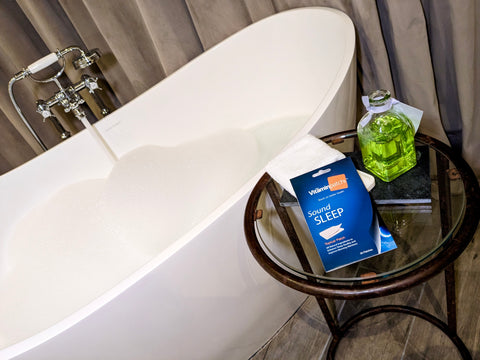 Our Sound Sleep patch on a table beside a bubble bath