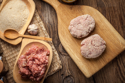 raw meat patties ready to be fried