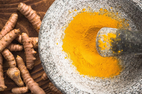 grounded turmeric in a mortar and pestle