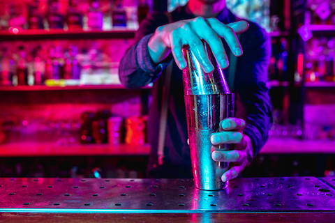 bartender shaking drink with cocktail shaker