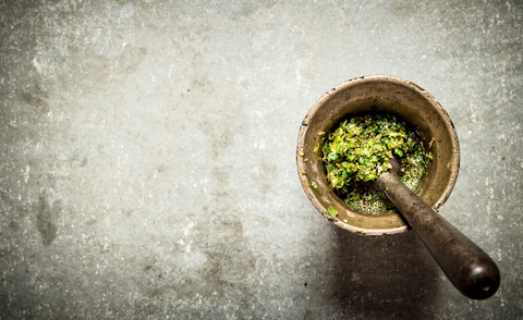 mortar and pestle with herbs