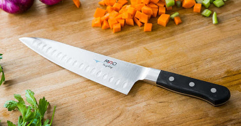Chefs knife on chopping board