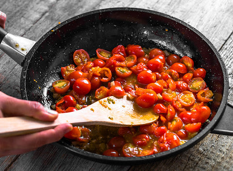 Tomatoes cooking in pan