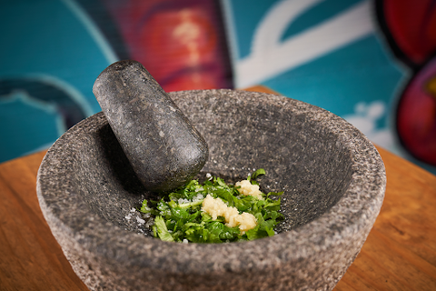 granite mortar and pestle with garlic and herbs