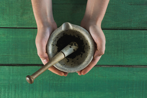 hands holding mortar and pestle
