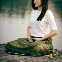 woman meditating with frankincense roll-on next to her