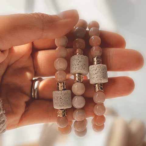 person holding sunstone bracelets