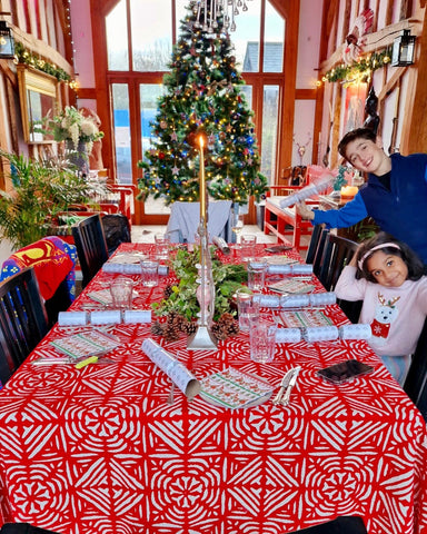 large Christmas tree with red applique tablecloth