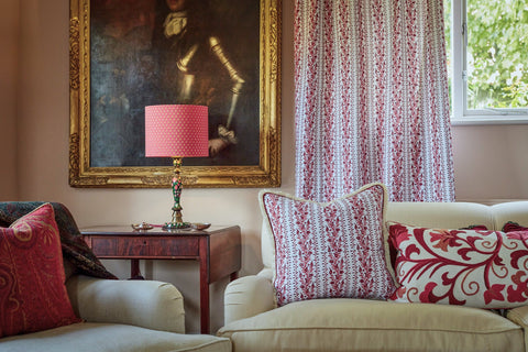 drawing room with cushions, curtain and silk coral lampshade