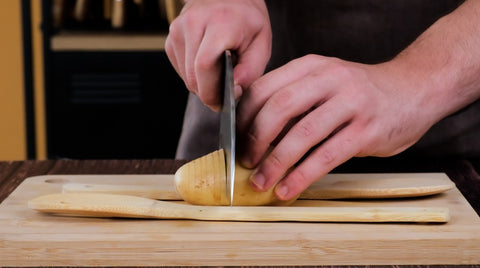 Step two of cutting a hasselback potato