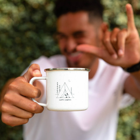 person holding happy camper mug