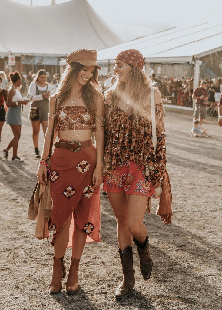 Two women walking having fun at Bluesfest Byron Bay wearing Spell