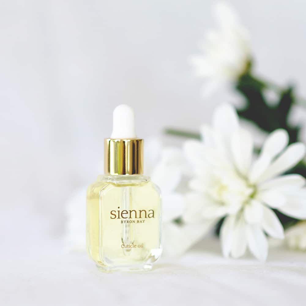 Cuticle oil in glass bottle with golden dropper by sienna