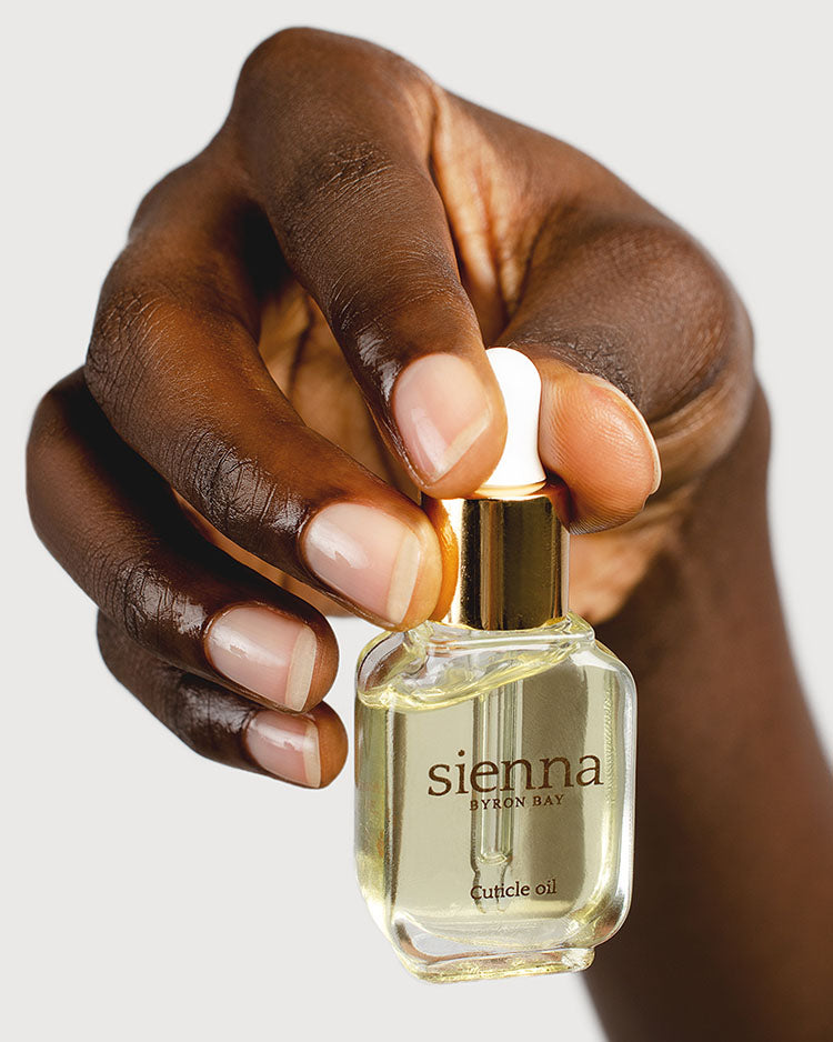Hand holding Cuticle oil bottle by Sienna Byron Bay