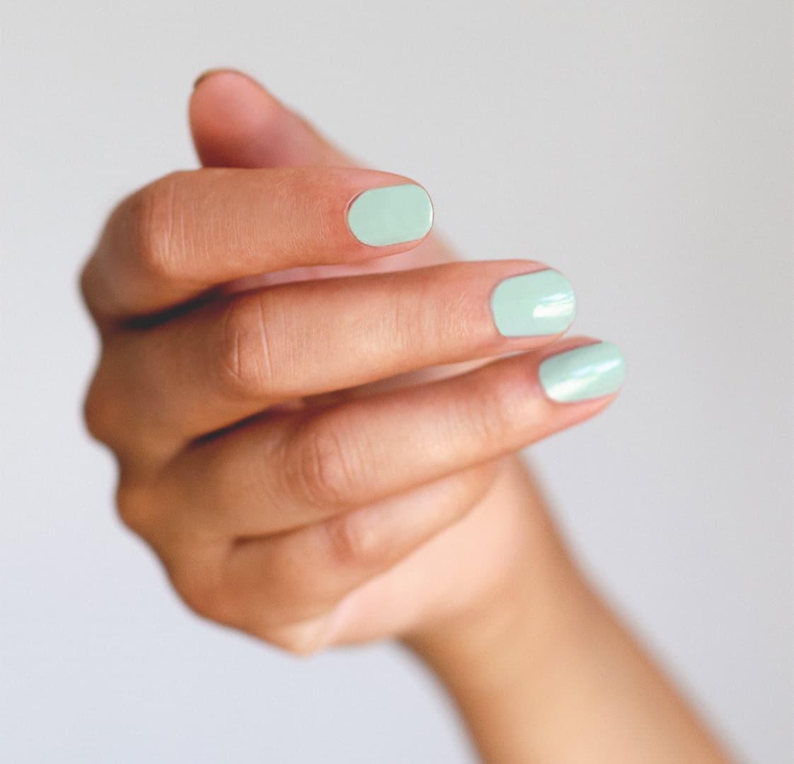 pastel green nail polish hand swatch on medium skin tone by sienna