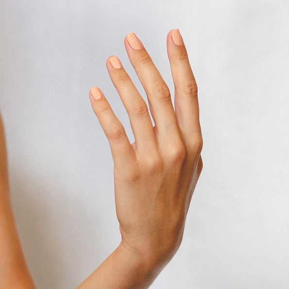 Peach nude nail polish hand swatch on fair skin tone by sienna